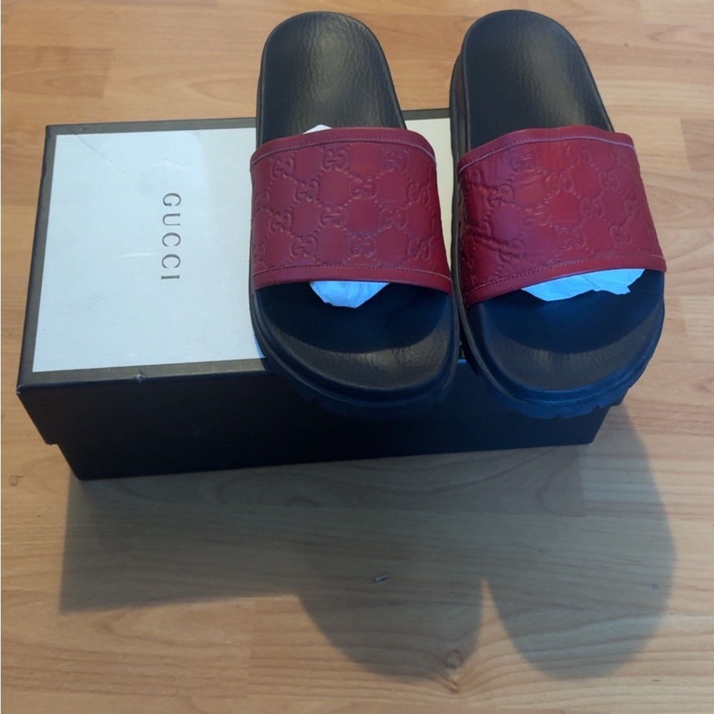 100% authentic Gucci Men’s Red Leather Embossed Slide Sandals with Black Footbed